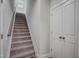 Carpeted stairway with neutral walls leading to the upper level and a large storage closet at 195 Duncan Creek Rd # 123, Lillington, NC 27546