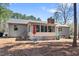 Spacious backyard features an outdoor seating area, screened porch, and mature trees at 2 Edgestone Pl, Chapel Hill, NC 27517