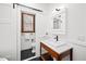Bathroom with a pedestal sink, toilet, medicine cabinet, and a window with wood trim at 2 Edgestone Pl, Chapel Hill, NC 27517