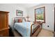 Bedroom featuring a wood-framed bed, patterned bedding, and wood-framed windows at 2 Edgestone Pl, Chapel Hill, NC 27517
