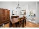 Cozy dining room with a wooden table, modern chandelier, and bright natural light at 2 Edgestone Pl, Chapel Hill, NC 27517