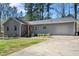 Inviting one-story home featuring a red door and an attached garage at 2 Edgestone Pl, Chapel Hill, NC 27517