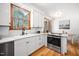 Kitchen showcasing white cabinets, stainless steel oven and wood-framed windows at 2 Edgestone Pl, Chapel Hill, NC 27517