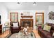 Cozy living room with a brick fireplace and comfortable leather furniture at 2 Edgestone Pl, Chapel Hill, NC 27517