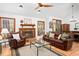 Spacious living room with a brick fireplace and hardwood floors at 2 Edgestone Pl, Chapel Hill, NC 27517