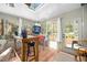 Sunroom with large windows, skylight, workstation, and a vintage pinball machine at 2 Edgestone Pl, Chapel Hill, NC 27517