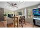 Sunroom with skylights, large windows, a workspace, and a vintage pinball machine at 2 Edgestone Pl, Chapel Hill, NC 27517