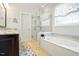 Luxurious bathroom featuring a soaking tub, glass-enclosed shower, and elegant fixtures at 2006 Prairie Ridge Ct, Fuquay Varina, NC 27526