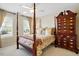 Charming bedroom with a four-poster bed, decorative linens, and plenty of natural light at 2006 Prairie Ridge Ct, Fuquay Varina, NC 27526