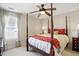 Inviting bedroom with a four-poster bed, soft bedding, and a ceiling fan for added comfort at 2006 Prairie Ridge Ct, Fuquay Varina, NC 27526