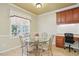 Cozy breakfast nook featuring a glass-top table, designer chairs, a workstation, and natural light at 2006 Prairie Ridge Ct, Fuquay Varina, NC 27526