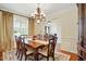 Elegant dining room with hardwood floors, chandelier, and large windows at 2006 Prairie Ridge Ct, Fuquay Varina, NC 27526