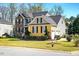 Well maintained house with manicured lawn, with view of the side facing two car garage at 2006 Prairie Ridge Ct, Fuquay Varina, NC 27526