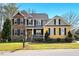 Charming home features a manicured lawn, brick accents, a porch and inviting curb appeal at 2006 Prairie Ridge Ct, Fuquay Varina, NC 27526