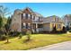 Charming two-story home with a landscaped yard, stone accents and covered entryway at 2006 Prairie Ridge Ct, Fuquay Varina, NC 27526