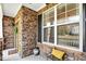 Inviting front porch with stone accents, black shutters, and space for seating at 2006 Prairie Ridge Ct, Fuquay Varina, NC 27526