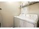 Functional laundry room featuring a washer, dryer, and shelving for storage solutions at 2006 Prairie Ridge Ct, Fuquay Varina, NC 27526