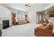 Bright living room with fireplace, large windows, and view to the kitchen at 2006 Prairie Ridge Ct, Fuquay Varina, NC 27526