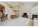 Inviting living room featuring a fireplace, high ceilings, and a staircase leading to the second floor at 2006 Prairie Ridge Ct, Fuquay Varina, NC 27526