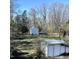 Picturesque backyard featuring sheds, open space, and lush greenery, perfect for outdoor activities at 2121 Allensville Rd, Roxboro, NC 27574