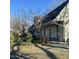A long, ranch-style home with a series of covered patios extends into the yard at 2121 Allensville Rd, Roxboro, NC 27574