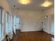 Spacious living room with hardwood floors, natural light, and multiple electrical outlets at 2121 Allensville Rd, Roxboro, NC 27574
