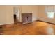 Living room showcasing a brick fireplace, hardwood floors, and natural light at 2121 Allensville Rd, Roxboro, NC 27574