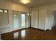 Living room with hardwood floors, ample natural light, and a white Murphy bed at 2121 Allensville Rd, Roxboro, NC 27574