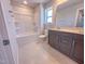 Bathroom features a combination shower and tub, and a vanity with gray cabinetry at 217 Duncan Creek Rd # 124, Lillington, NC 27546