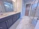 Bathroom boasts double sink vanity, marble floors, and glass shower with tiled walls at 217 Duncan Creek Rd # 124, Lillington, NC 27546
