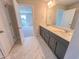 Bathroom featuring double sink vanity, marble floors, and access to the bedroom at 217 Duncan Creek Rd # 124, Lillington, NC 27546