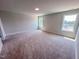 Spacious carpeted bedroom featuring neutral walls and natural light from two windows at 217 Duncan Creek Rd # 124, Lillington, NC 27546