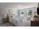 Bedroom with light neutral walls and furnishings, and two windows offering ample natural light at 217 Duncan Creek Rd # 124, Lillington, NC 27546