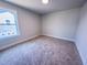 Bright bedroom featuring plush carpet, a window offering natural light and neutral paint at 217 Duncan Creek Rd # 124, Lillington, NC 27546