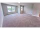 Open and bright bedroom featuring neutral walls, carpet, and abundant natural light from windows at 217 Duncan Creek Rd # 124, Lillington, NC 27546