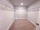 Walk-in closet with carpeted floors and wire shelving, providing ample storage space at 217 Duncan Creek Rd # 124, Lillington, NC 27546