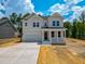 Charming two-story home featuring a covered porch and an attached two-car garage at 217 Duncan Creek Rd # 124, Lillington, NC 27546