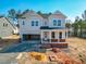 Two-story home with a covered front porch and an attached two-car garage, set on a partially cleared lot at 217 Duncan Creek Rd # 124, Lillington, NC 27546