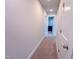Neutral hallway leading to a bathroom with recessed lights, and clean white trim at 217 Duncan Creek Rd # 124, Lillington, NC 27546