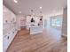 Spacious kitchen with white cabinets, modern lighting, and a large center island at 217 Duncan Creek Rd # 124, Lillington, NC 27546