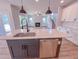 Open kitchen featuring a central island, stainless steel appliances, and views to living room at 217 Duncan Creek Rd # 124, Lillington, NC 27546