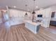 Bright, open kitchen featuring white cabinets, a center island, and stainless steel appliances at 217 Duncan Creek Rd # 124, Lillington, NC 27546