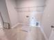 Functional laundry room with tile floors, utility connections, and overhead wire shelving at 217 Duncan Creek Rd # 124, Lillington, NC 27546