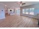 Open-concept living space includes kitchen, dining, and living areas with hardwood floors and large windows at 217 Duncan Creek Rd # 124, Lillington, NC 27546