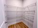 Walk-in pantry with sturdy wire shelving for optimal storage solutions, plus wood-look flooring at 217 Duncan Creek Rd # 124, Lillington, NC 27546