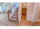 Carpeted staircase with white railings, wood trim and an adjacent coat closet at 217 Duncan Creek Rd # 124, Lillington, NC 27546