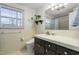 A bathroom with black cabinets and a white sink at 2203 Canterbury Dr, Burlington, NC 27215