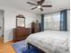 Bright bedroom with hardwood floors, a ceiling fan, and a large window with blue curtains at 2203 Canterbury Dr, Burlington, NC 27215