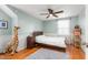 A light green bedroom featuring hardwood floors and a bed with white linens at 2203 Canterbury Dr, Burlington, NC 27215