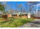 Charming brick home featuring mature trees and a well-maintained lawn and driveway at 2203 Canterbury Dr, Burlington, NC 27215